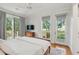Charming main bedroom with hardwood floors and multiple windows offering picturesque outdoor views at 2217 Ramsay St, Charleston, SC 29412