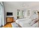 Bright main bedroom with hardwood floors, large windows, and ensuite bathroom offers a serene retreat at 2217 Ramsay St, Charleston, SC 29412