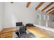 Well-lit office space featuring a spacious wooden desk, comfortable chair and windows that let in natural light at 2217 Ramsay St, Charleston, SC 29412
