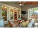 Cozy screened porch with indoor outdoor flow to living room, hanging chair, and TV at 2217 Ramsay St, Charleston, SC 29412