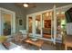 Inviting screened porch with mini-fridge, indoor/outdoor flow, and comfortable furniture at 2217 Ramsay St, Charleston, SC 29412