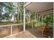Relaxing covered porch with rocking chairs and a view of the serene backyard and water at 2217 Ramsay St, Charleston, SC 29412