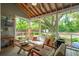 Comfortable screened porch features string lights, hanging chair and lots of outdoor seating at 2217 Ramsay St, Charleston, SC 29412