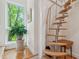 Unique spiral staircase with wooden steps, metal support, and a view from a large window at 2217 Ramsay St, Charleston, SC 29412