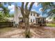 Rear view of a two-story home with a deck and a screened porch in a spacious backyard at 237 Dillard Dr, Goose Creek, SC 29445