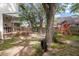 Backyard with mature trees, swing set, tire swing, and deck area at 237 Dillard Dr, Goose Creek, SC 29445