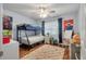 Bright bedroom features a bunk bed, ceiling fan, colorful decor, and a hardwood floor at 237 Dillard Dr, Goose Creek, SC 29445