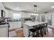 Bright kitchen features white cabinets, stainless steel appliances, and a kitchen island with bar stool seating at 237 Dillard Dr, Goose Creek, SC 29445