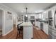 Bright kitchen features white cabinets, stainless steel appliances, and a kitchen island with bar stool seating at 237 Dillard Dr, Goose Creek, SC 29445
