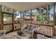 This covered porch features outdoor seating and a view of the backyard and adjacent properties at 237 Dillard Dr, Goose Creek, SC 29445