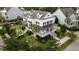 Aerial view of a beautiful home with a front porch, lush landscaping, and a well-maintained lawn at 2489 Daniel Island Dr, Daniel Island, SC 29492