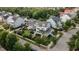Aerial view of a neighborhood showcasing manicured lawns and tree-lined streets surrounding elegant homes at 2489 Daniel Island Dr, Daniel Island, SC 29492