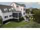 Landscaped backyard with an outdoor seating area, well-manicured lawn, and a charming white home with black shutters at 2489 Daniel Island Dr, Daniel Island, SC 29492