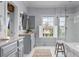 Bright bathroom featuring a soaking tub, a glass-enclosed shower, and double vanity at 2489 Daniel Island Dr, Daniel Island, SC 29492