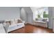 Cozy bedroom with a sitting area, featuring bright natural light and hardwood floors at 2489 Daniel Island Dr, Daniel Island, SC 29492
