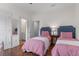 Charming bedroom featuring twin beds with matching blue headboards and hardwood flooring at 2489 Daniel Island Dr, Daniel Island, SC 29492