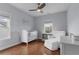 Cozy Bedroom features a crib, comfortable armchair, and neutral color palette at 2489 Daniel Island Dr, Daniel Island, SC 29492