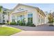 Charming exterior of The Dime Eatery, featuring large windows, lush landscaping, and a welcoming brick pathway at 2489 Daniel Island Dr, Daniel Island, SC 29492