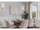 Cozy dining room features wainscoting, a modern light fixture, and a beautiful garden view at 2489 Daniel Island Dr, Daniel Island, SC 29492