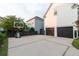 Spacious driveway leading to a two-car garage, complemented by a basketball hoop and lush landscaping at 2489 Daniel Island Dr, Daniel Island, SC 29492