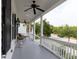 Spacious front porch with white columns, ceiling fans, and black shutters enhancing curb appeal at 2489 Daniel Island Dr, Daniel Island, SC 29492