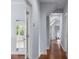 Well-lit hallway with hardwood floors and open doorways leading to various rooms at 2489 Daniel Island Dr, Daniel Island, SC 29492