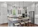 Elegant kitchen featuring white cabinetry, a gray island with seating, and stainless steel appliances at 2489 Daniel Island Dr, Daniel Island, SC 29492