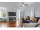 Comfortable living room area with a sofa, TV, and hardwood floors at 2489 Daniel Island Dr, Daniel Island, SC 29492