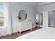 The main bedroom features a stylish white dresser and hardwood flooring with a lovely mirror at 2489 Daniel Island Dr, Daniel Island, SC 29492