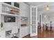 Bright office space with custom built-ins, a desk, and French doors to an adjacent room at 2489 Daniel Island Dr, Daniel Island, SC 29492