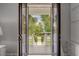 Inviting front porch and view of lush landscaping and charming neighborhood from inside at 2489 Daniel Island Dr, Daniel Island, SC 29492