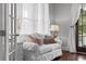 Bright sitting area features a plush white sofa, hardwood floors, and lots of natural light from sheer curtains at 2489 Daniel Island Dr, Daniel Island, SC 29492