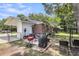 Spacious backyard patio featuring seating, BBQ grill, mature trees, and access to the house at 2631 Ridgewood Ave, Charleston, SC 29414