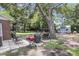 Large backyard with patio, mature trees, grilling area, a shed, and ample space for outdoor activities at 2631 Ridgewood Ave, Charleston, SC 29414