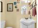 Bathroom featuring a white vanity, framed mirror, decorative artwork, and neutral yellow walls at 2631 Ridgewood Ave, Charleston, SC 29414