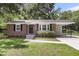 Charming red brick home featuring a well-manicured lawn, traditional design, and convenient carport at 2631 Ridgewood Ave, Charleston, SC 29414