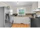 Bright kitchen with stainless steel appliances, ample counter space, and a window over the sink at 2631 Ridgewood Ave, Charleston, SC 29414