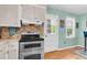 The kitchen shows updated appliances and decor, with an exit door to the side yard at 2631 Ridgewood Ave, Charleston, SC 29414