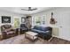 Cozy living room featuring hardwood floors, a ceiling fan, and large windows, offering natural light at 2631 Ridgewood Ave, Charleston, SC 29414