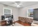 Well-lit office space with hardwood floors, a glass desk, built-in shelving, and two large windows at 2631 Ridgewood Ave, Charleston, SC 29414