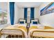 Bright bedroom featuring two gold twin beds, blue accents and comfortable bedding at 2666 Poplin Ave, North Charleston, SC 29405