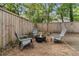 Backyard firepit and chair seating area with a new wooden fence at 2666 Poplin Ave, North Charleston, SC 29405