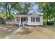 Charming home with a well-maintained front yard and decorative flags at 2666 Poplin Ave, North Charleston, SC 29405