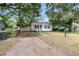 Home and front yard with large trees, a mailbox, and partial driveway at 2666 Poplin Ave, North Charleston, SC 29405