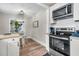 Well lit kitchen featuring stainless steel appliances, modern cabinets, and a view to the dining area at 2666 Poplin Ave, North Charleston, SC 29405