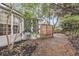 Private backyard featuring a screened-in porch window, wooden privacy fence, and mature trees at 2727 4 Winds Pl, Mount Pleasant, SC 29466