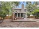 Inviting backyard featuring a screened-in porch, wooden deck, and lush greenery, perfect for relaxing and entertaining at 2727 4 Winds Pl, Mount Pleasant, SC 29466