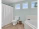 Bright bathroom featuring a toilet, tub, shower curtain and tiled flooring at 2727 4 Winds Pl, Mount Pleasant, SC 29466