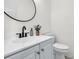 Contemporary bathroom features a white vanity with black fixtures and a decorative mirror at 2727 4 Winds Pl, Mount Pleasant, SC 29466
