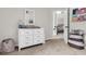 Cozy bedroom with a white dresser, stylish mirror, and a glimpse of a comfortable bed at 2727 4 Winds Pl, Mount Pleasant, SC 29466